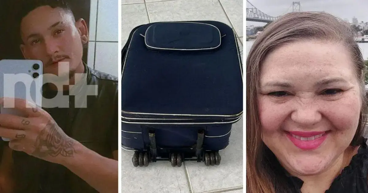 Um retrato de um homem, uma mala azul com rodinhas e um retrato de uma mulher sorrindo.