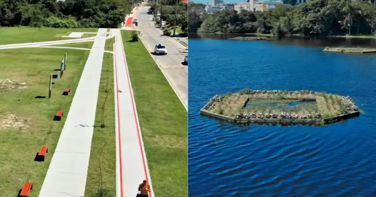 Vista de um parque com calçadas, bancos vermelhos e um lago com ilhas de vegetação.
