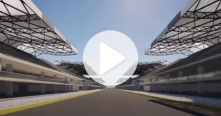 Perspectiva de um circuito, com arquibancadas cobertas em ambos os lados e uma pista ao centro.