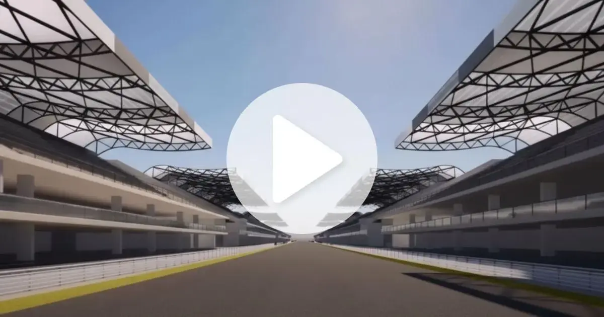 Perspectiva de um circuito, com arquibancadas cobertas em ambos os lados e uma pista ao centro.